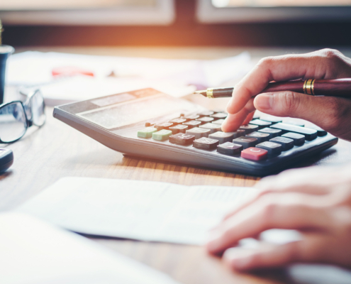 finance accounting concept. pen and calculator on table