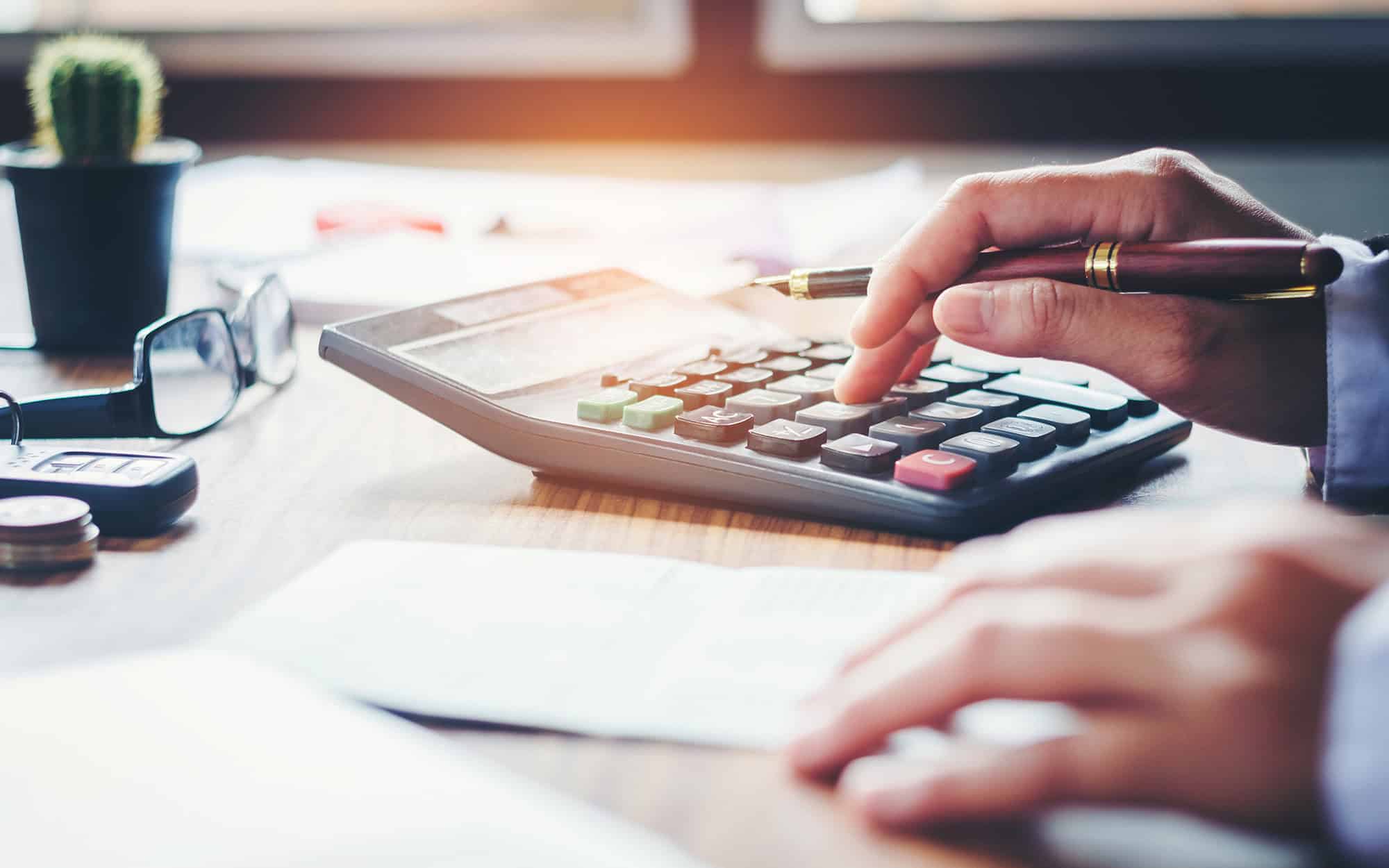 finance accounting concept. pen and calculator on table