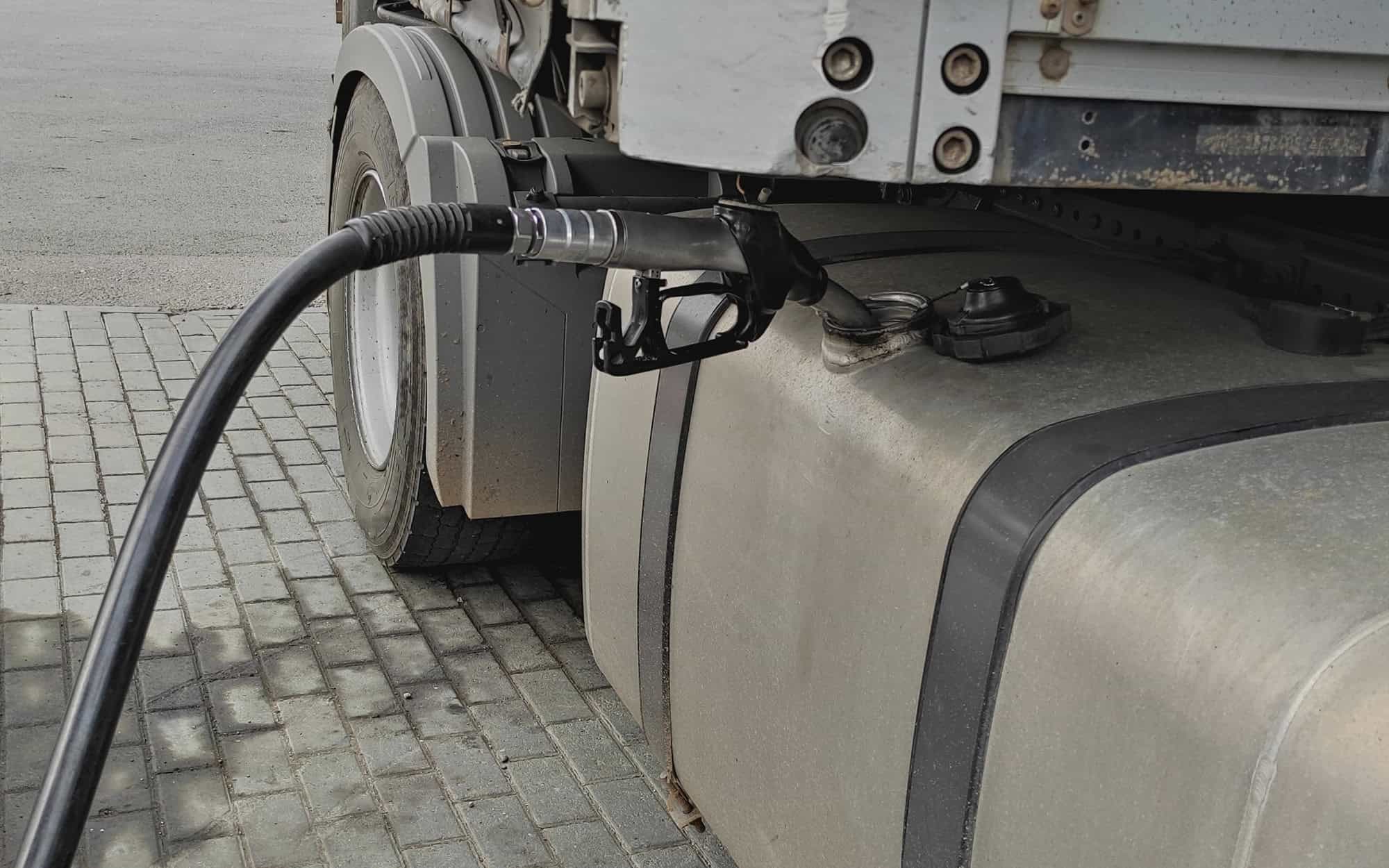 Fueling up a freight transport truck, side view